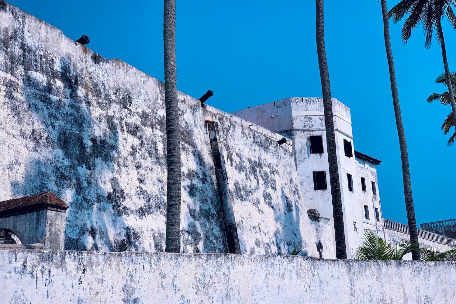 a concrete wall with birds perched on top of it